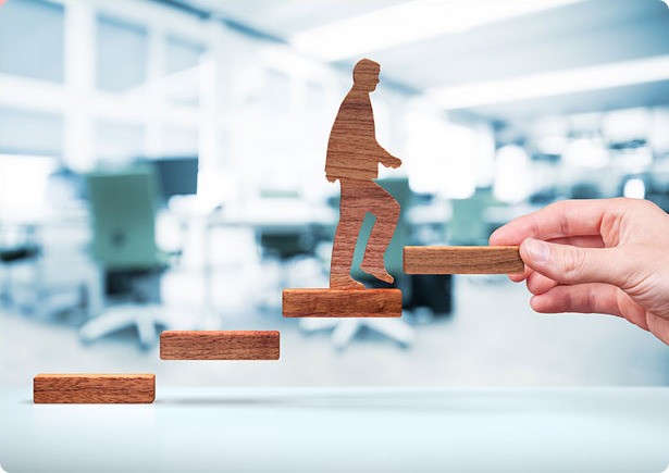 A hand placing the next step in front of someone climbing